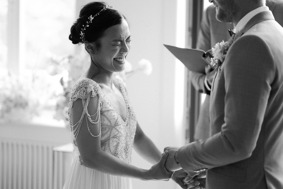 emotionales Reportagefoto: Braut lacht bei freier Trauung im Berliner Schloss