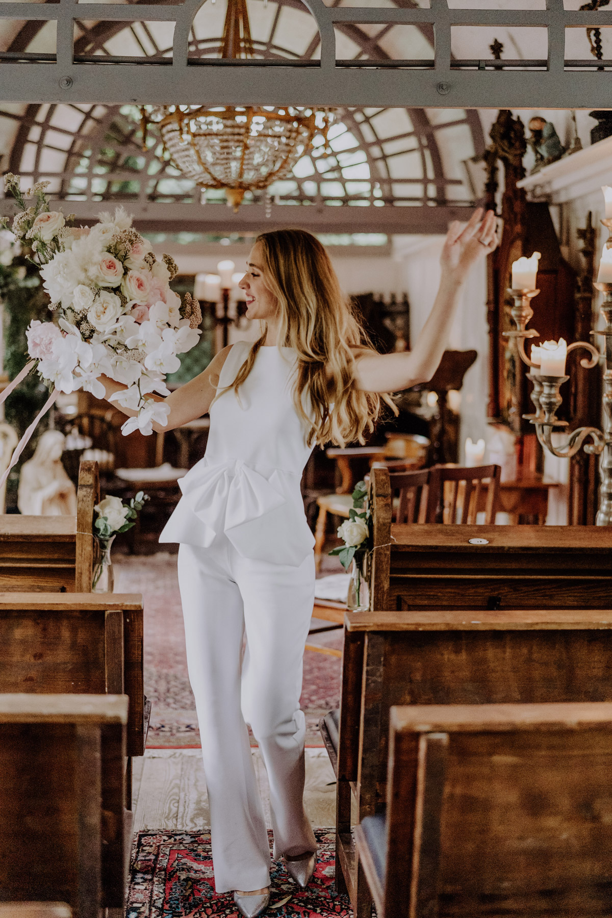 Hochzeitsplaner Braut im Standesamt Hosenanzug tanzt ausgelassen vor der Hochzeit in Berlin