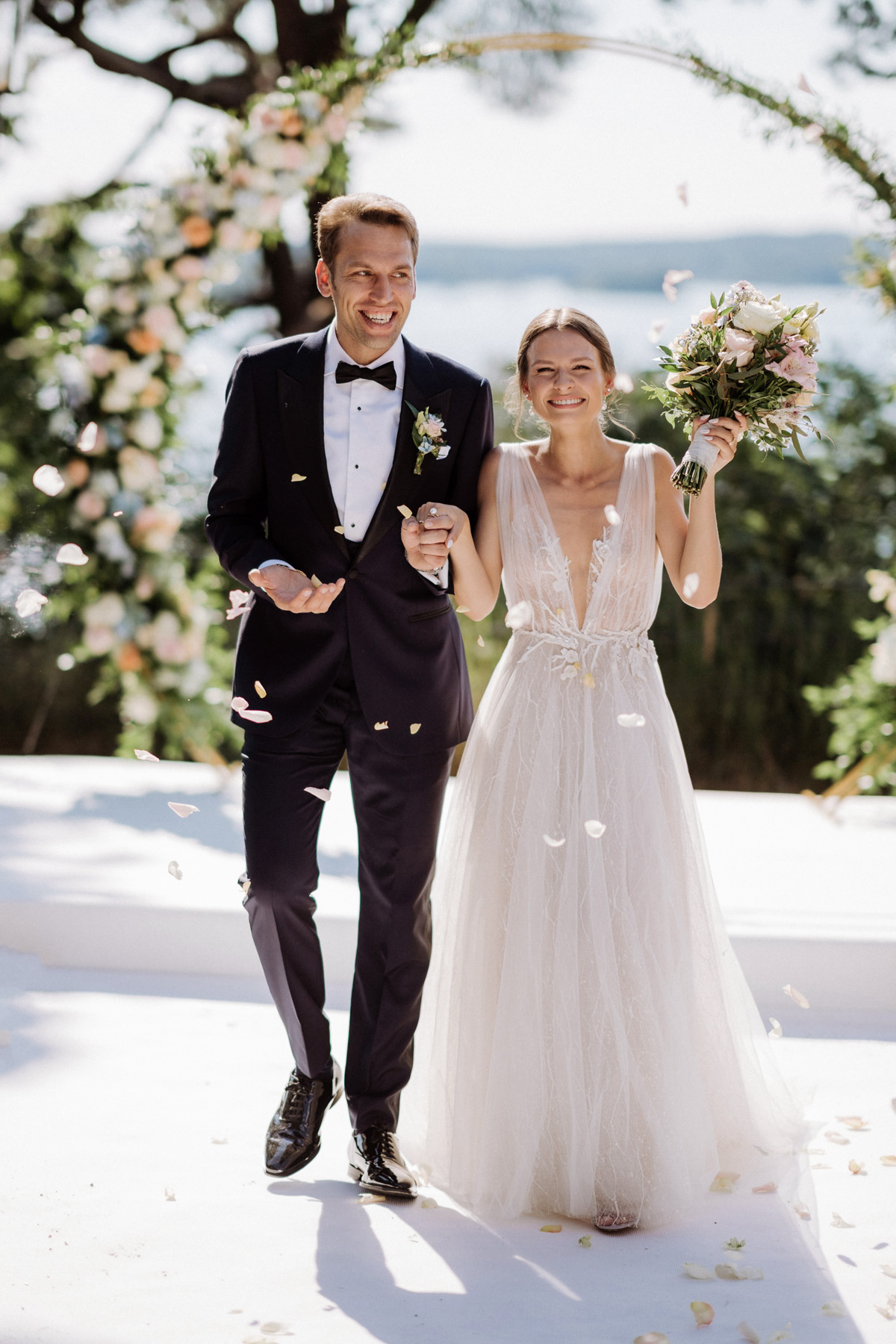 Brautpaar-Auszug mit Blütenregen bei einer Hochzeit im Restaurant Wannseeterrassen am Berliner Wannsee.