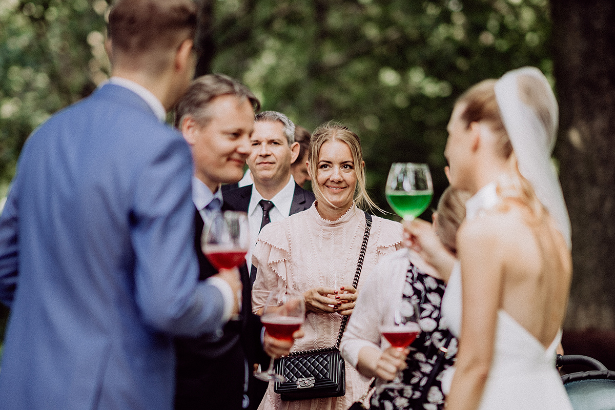 strahlende Gäste mit Getränken