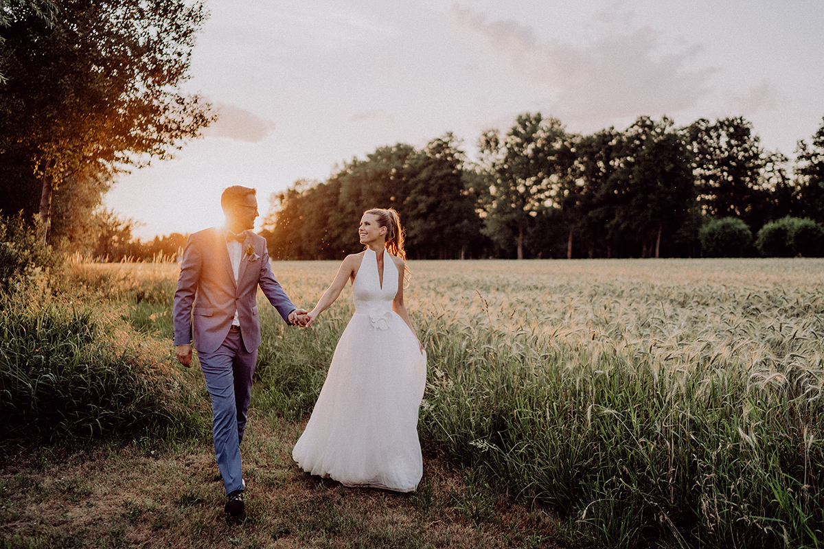 Hochzeitsfotografie Spreewald: Paar läuft lachend im Sonnenlicht