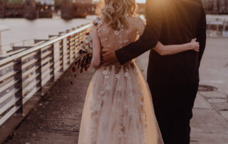 Elopement Berlin & Hochzeitsfotograf: Brautpaar spaziert im goldenen Licht an der Oberbaumbrücke