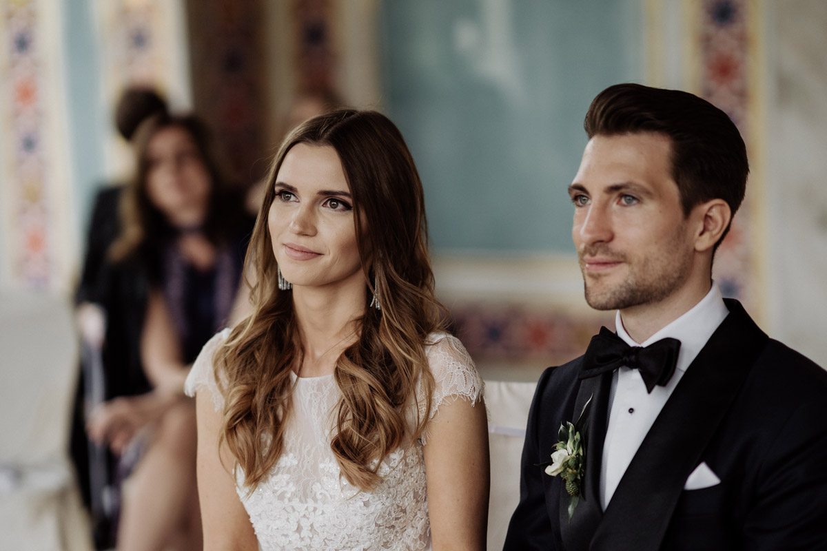 Authentische Hochzeitsfotos: Brautpaar lauscht bewegt der Rede der Standesbeamtin