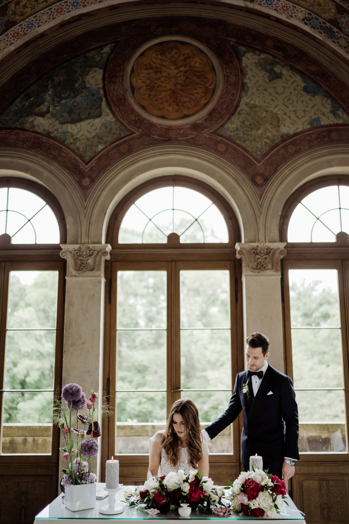 Offizieller Moment: Braut unterschreibt die Eheurkunde im lichtdurchfluteten Belvedere