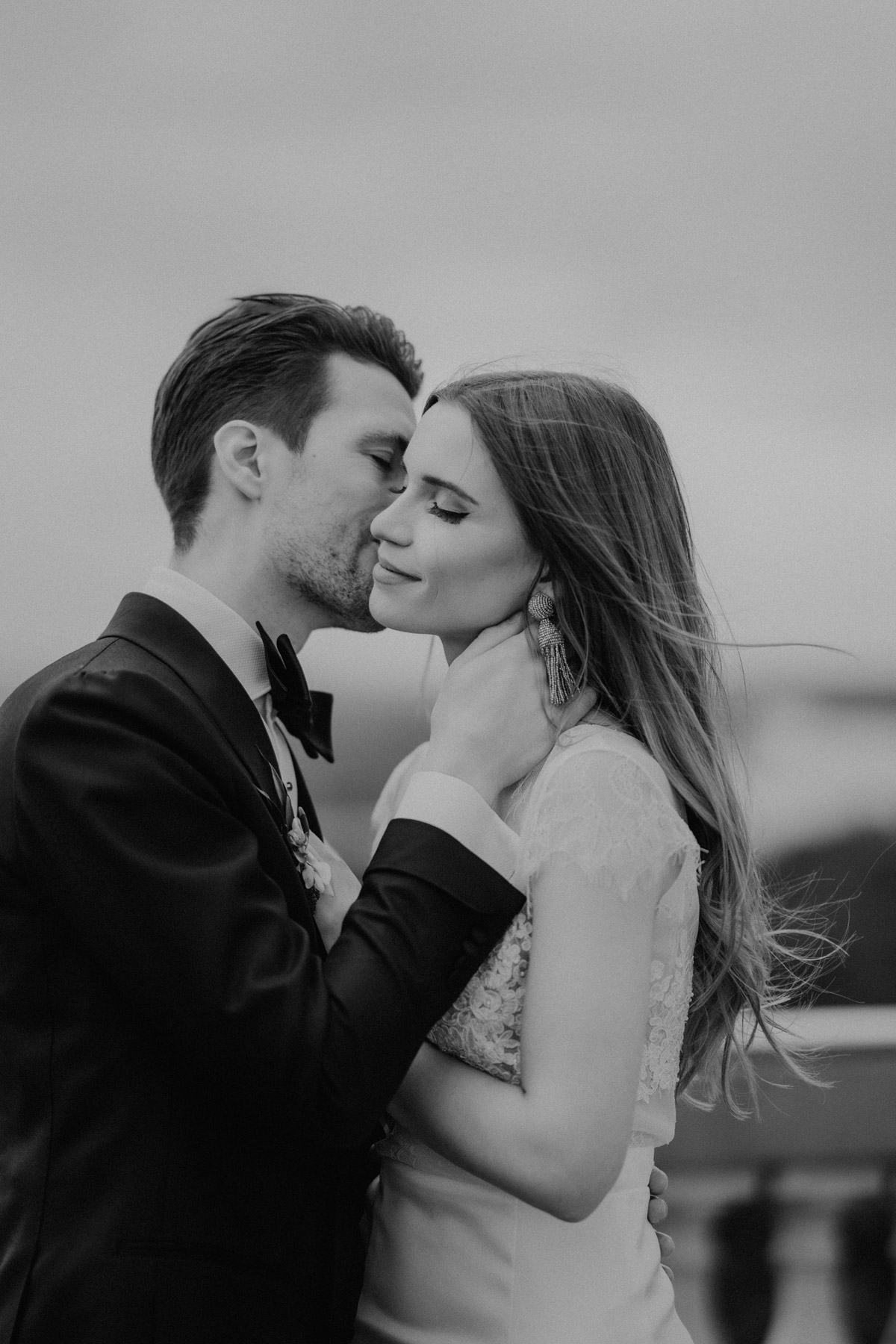 Intimer Moment: Bräutigam küsst Braut zärtlich auf die Wange – Schwarz-Weiß Close-up